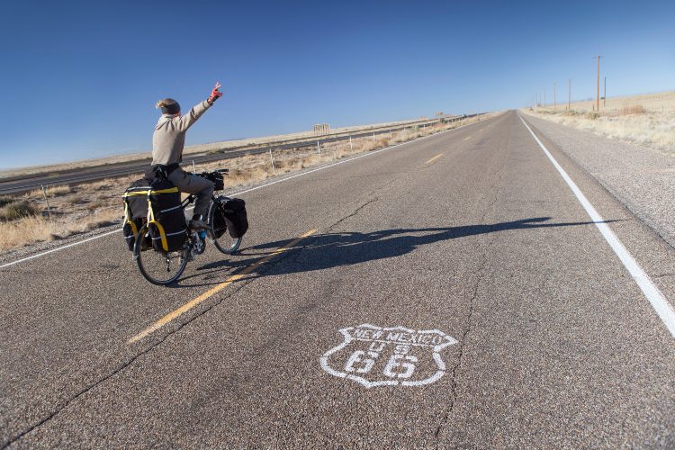 A cyclist rides down route 66, New Mexico